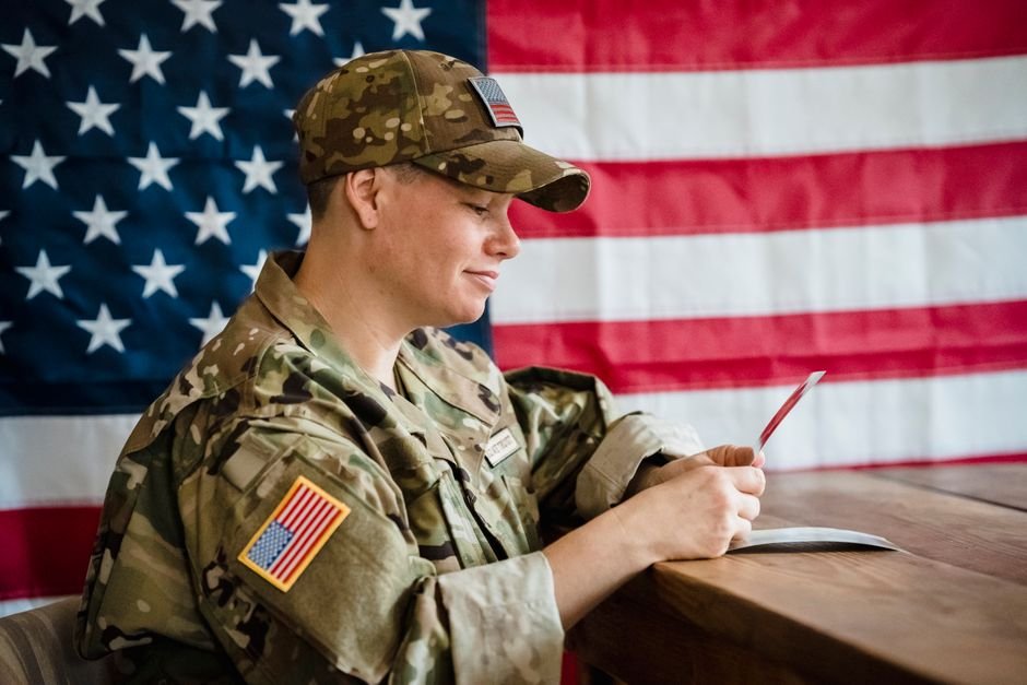 A surviving spouse reviewing VA DIC for surviving spouses paperwork at her kitchen table